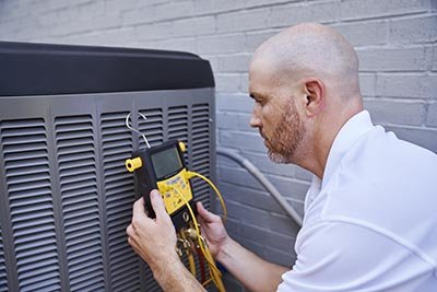 Technician Doing Maintenance On Air Conditioner